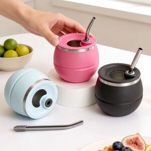 Wholesale modern stainless steel yerba mate gourd cups with functional lids in light blue, pink, and black colors on an office desk.