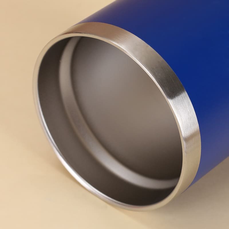 A close up view of the upper edge of a blue short travel mug showing a thick seamlessly polished unthreaded stainless steel lip.