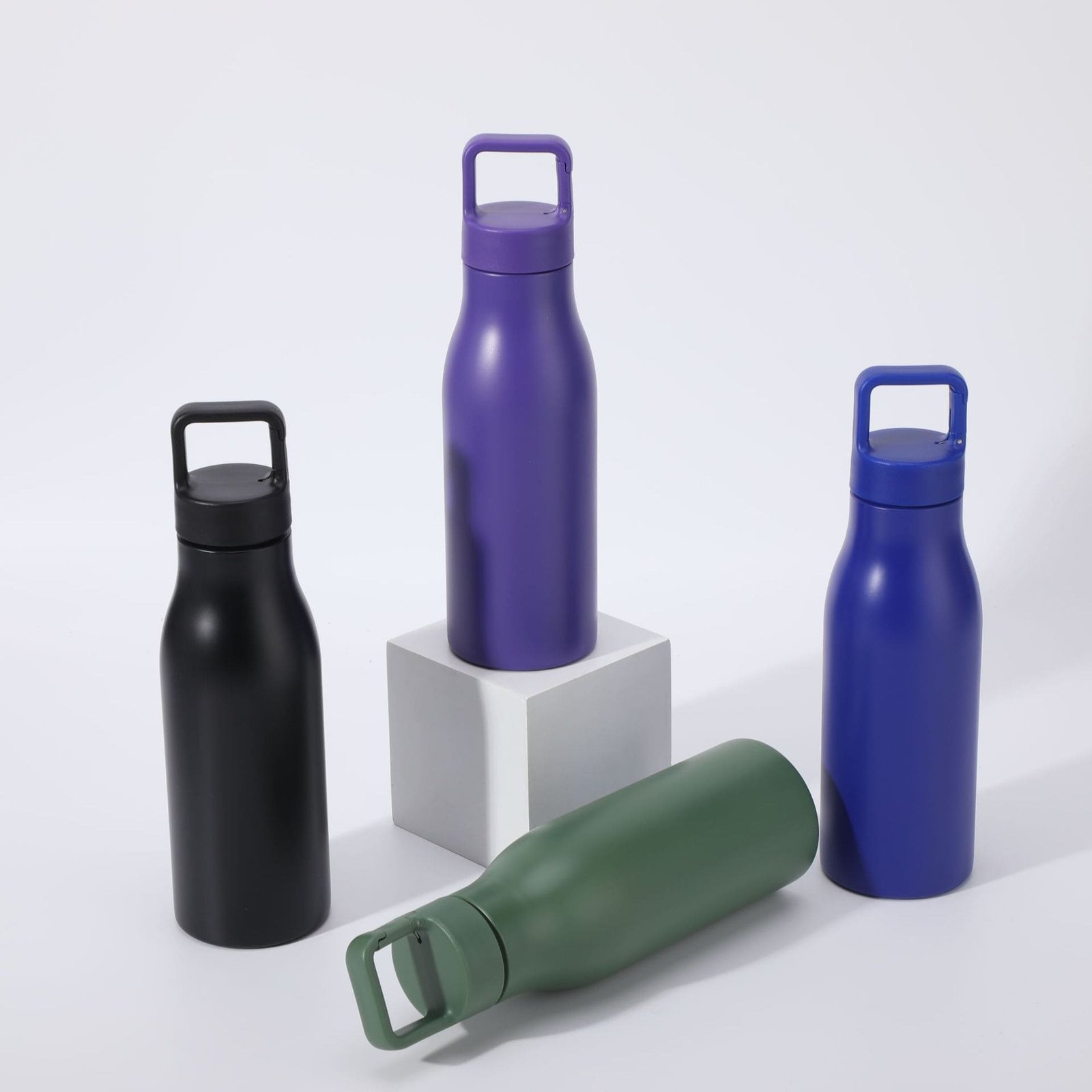 Bulk custom single wall stainless steel water bottle collection highlighting dynamic layout with green bottle resting horizontally