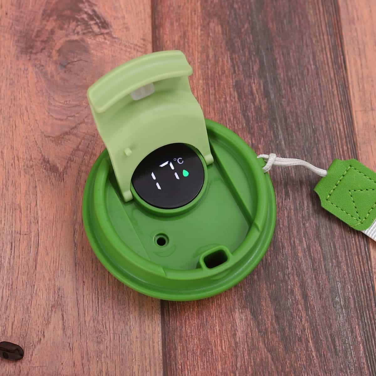 Top view of custom smart LED temperature display coffee cup cap showing green indicator ring and woven coffee carrying strap