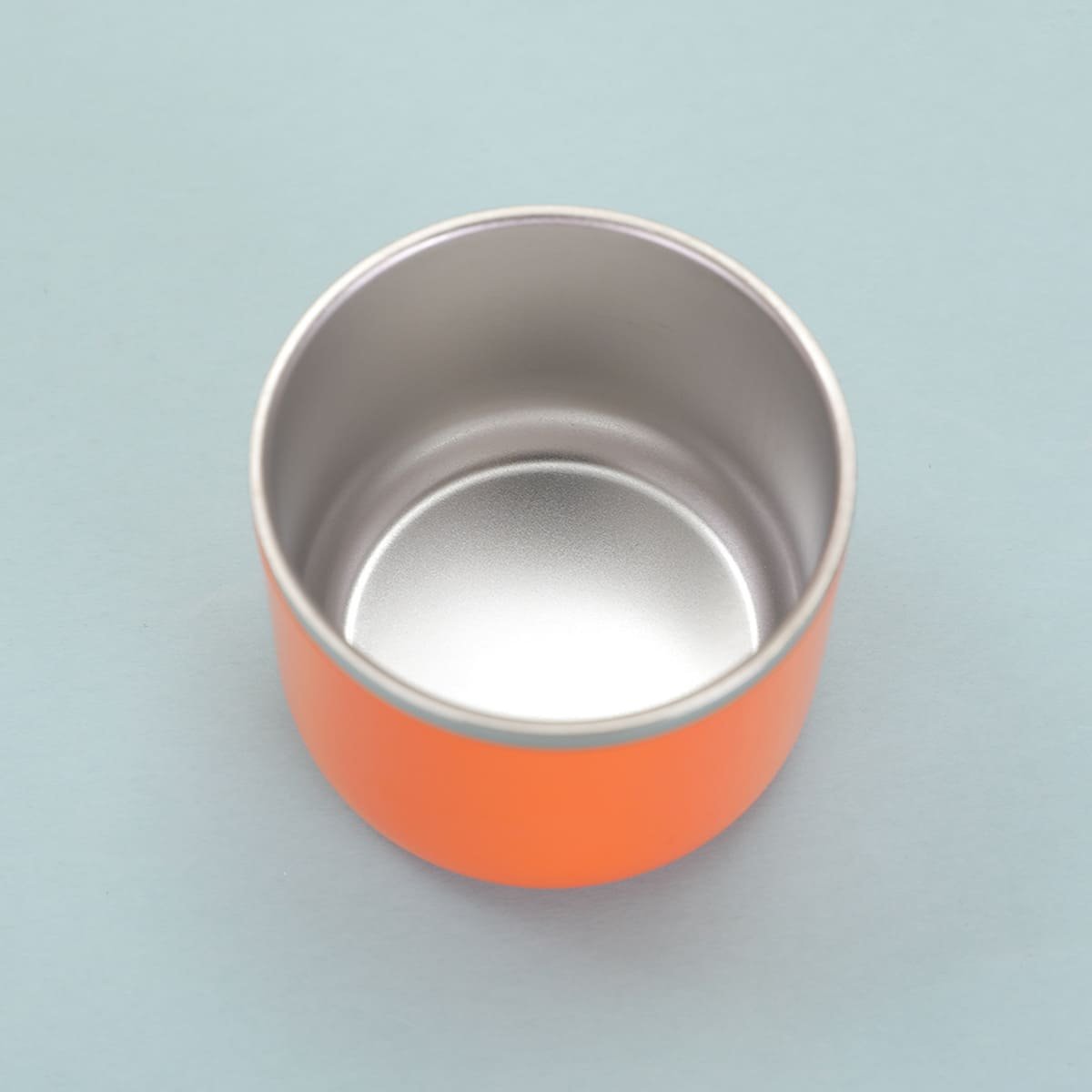 Top-down view of the detached insulated flask cap showing its food-grade stainless steel interior lining that serves as a practical drinking cup container.