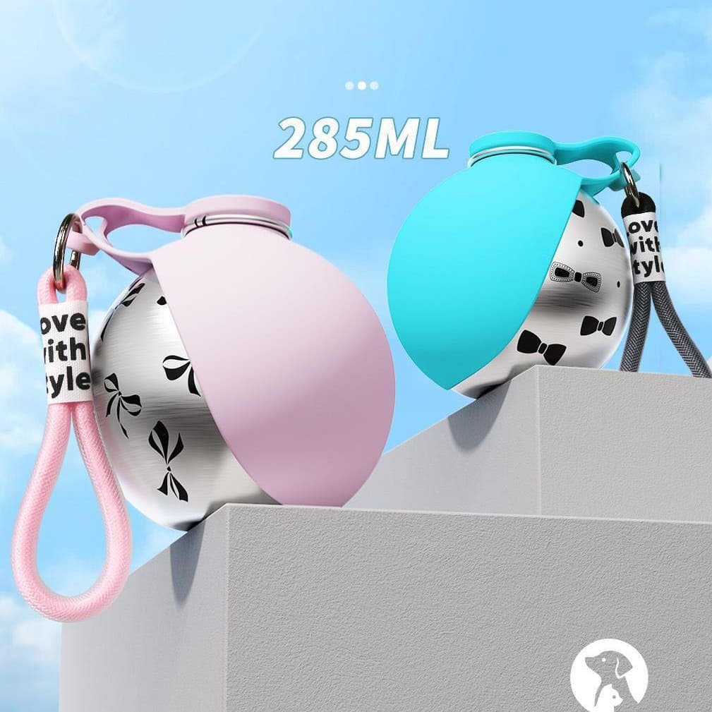 Two premium 285ml foldable silicone pet water bottles in pastel pink and tiffany blue showcased on a modern pedestal.