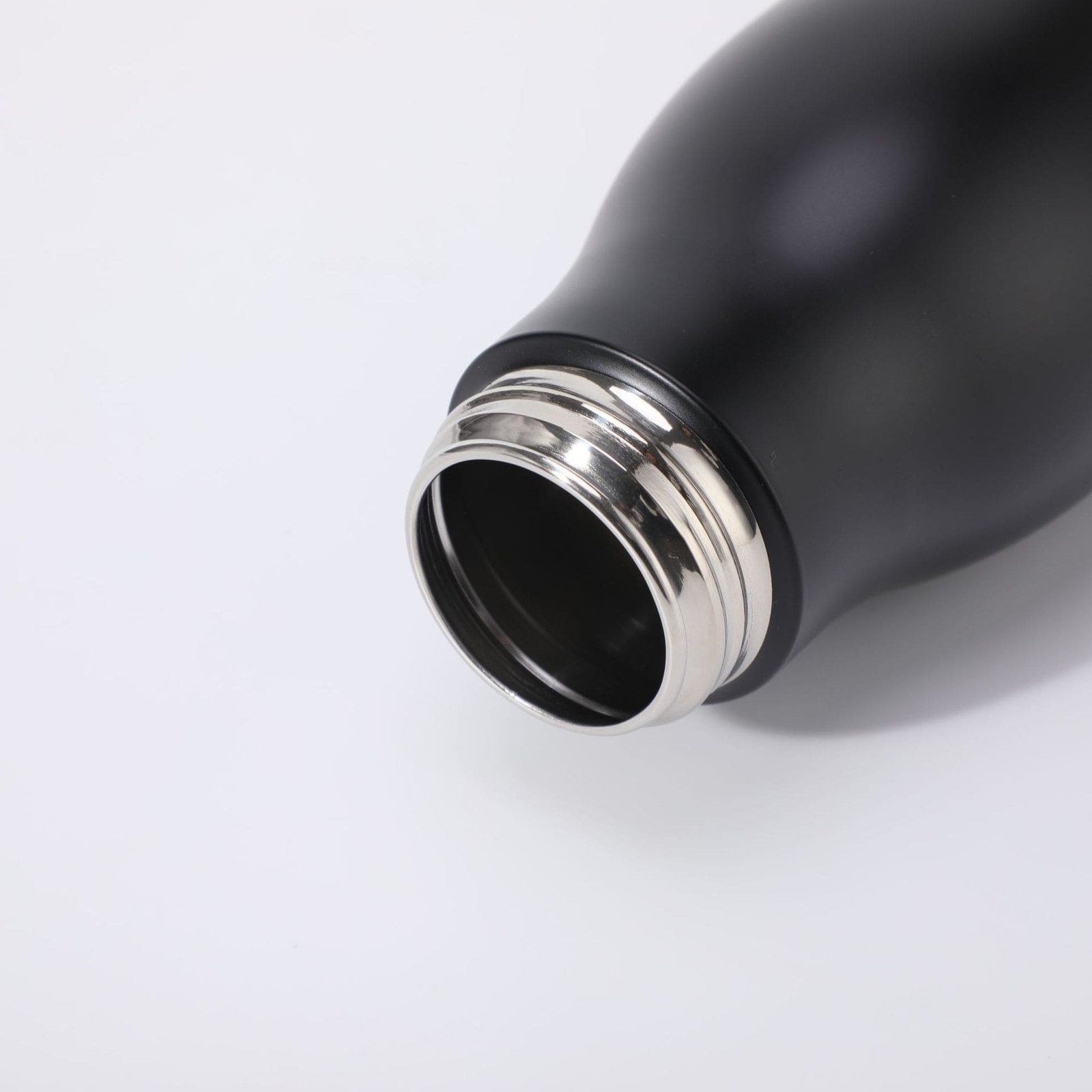 Top view looking into single wall stainless steel water bottle showing the mirror polished external thread profile.