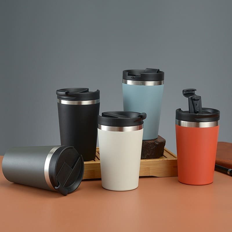 A collection of five 320ml vacuum coffee travel mug displayed in different matte colors including grey, black, white, blue, and coral.