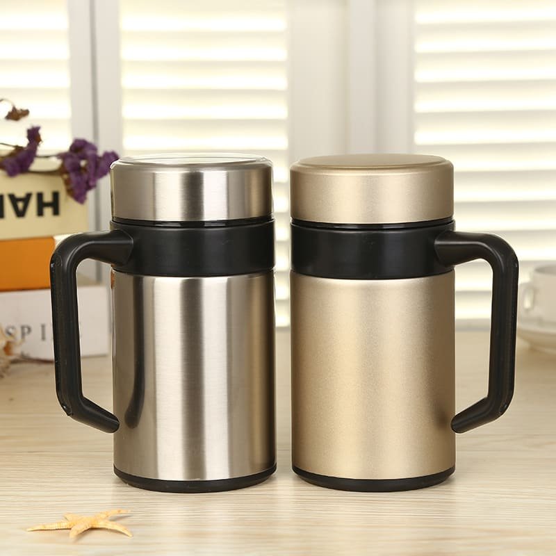 Two premium 400ml office stainless steel mug with handles in classic brushed silver and matte champagne gold on a desk.