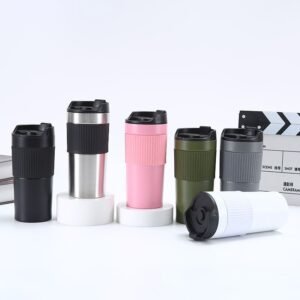 A row of six colorful stainless steel french press travel mugs in black, silver, pink, green, grey, and white colors standing on a white background.
