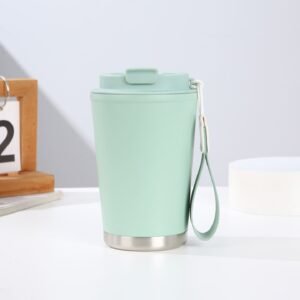 Wholesale 380ml insulated travel mug in pastel green with built-in carry strap and matte finish.