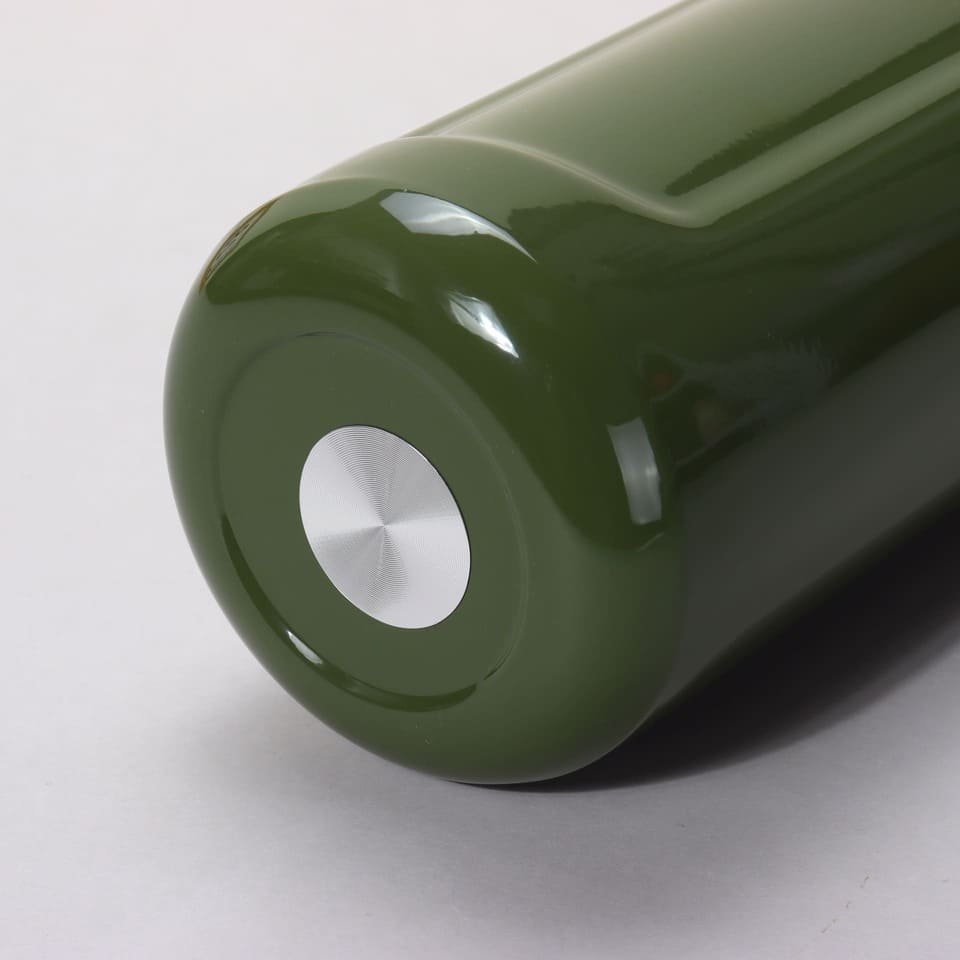 Close up of the olive green insulated bottle bottom featuring an inset circular brushed steel stabilizing plate.
