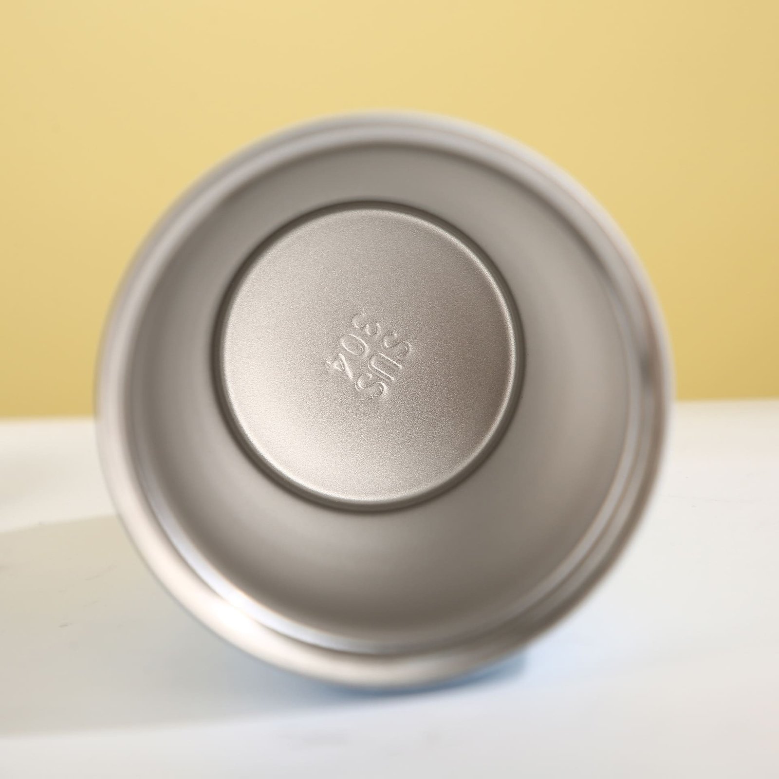Inside view of the 380ml travel mug chamber showing the authenticated food grade SUS 304 steel stamp at the bottom center.