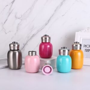Lineup of wholesale chubby egg-shaped mini vacuum insulated stainless steel flasks in diverse colorful pastel finishes.